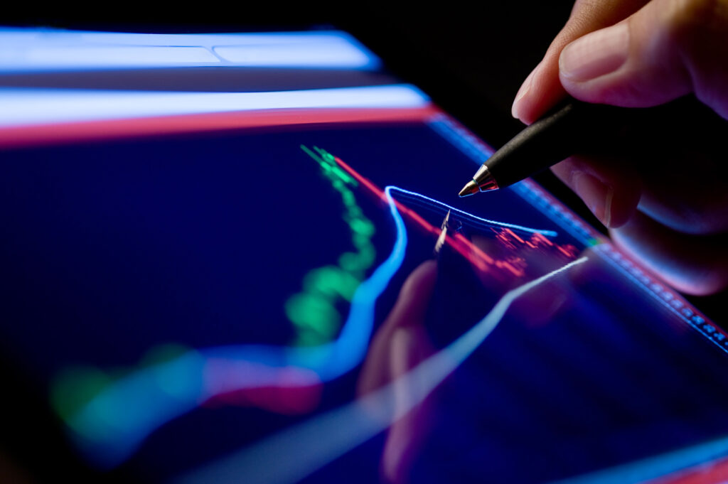 Market analysis - writing pen on screen